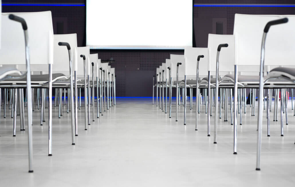 Canva Low Angle Photography of Pile of Stainless Steel Chairs With Hanging Projector Canvas 1